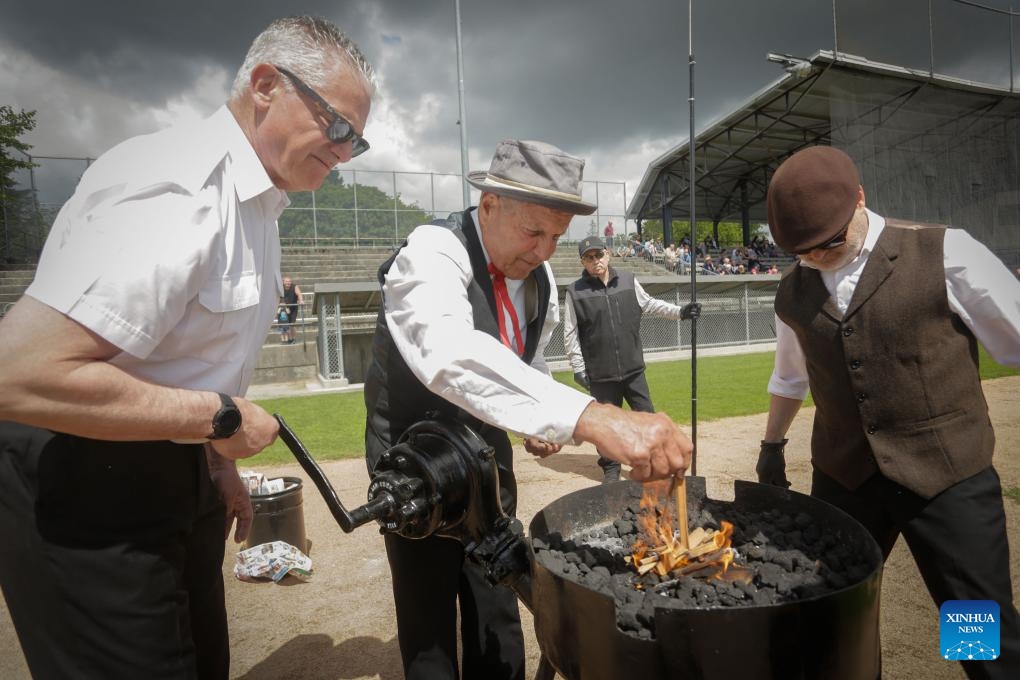 Members of the Ancient and Honourable Hyack Anvil Battery burn coal for anvil firing during the Victoria Day Anvil Battery Salute at Queen's Park Stadium in New Westminster, British Columbia, Canada, on May 20, 2024. Anvil salute is an annual tradition in the city of New Westminster dating back to the 1860s on Victoria Day.(Photo: Xinhua)
