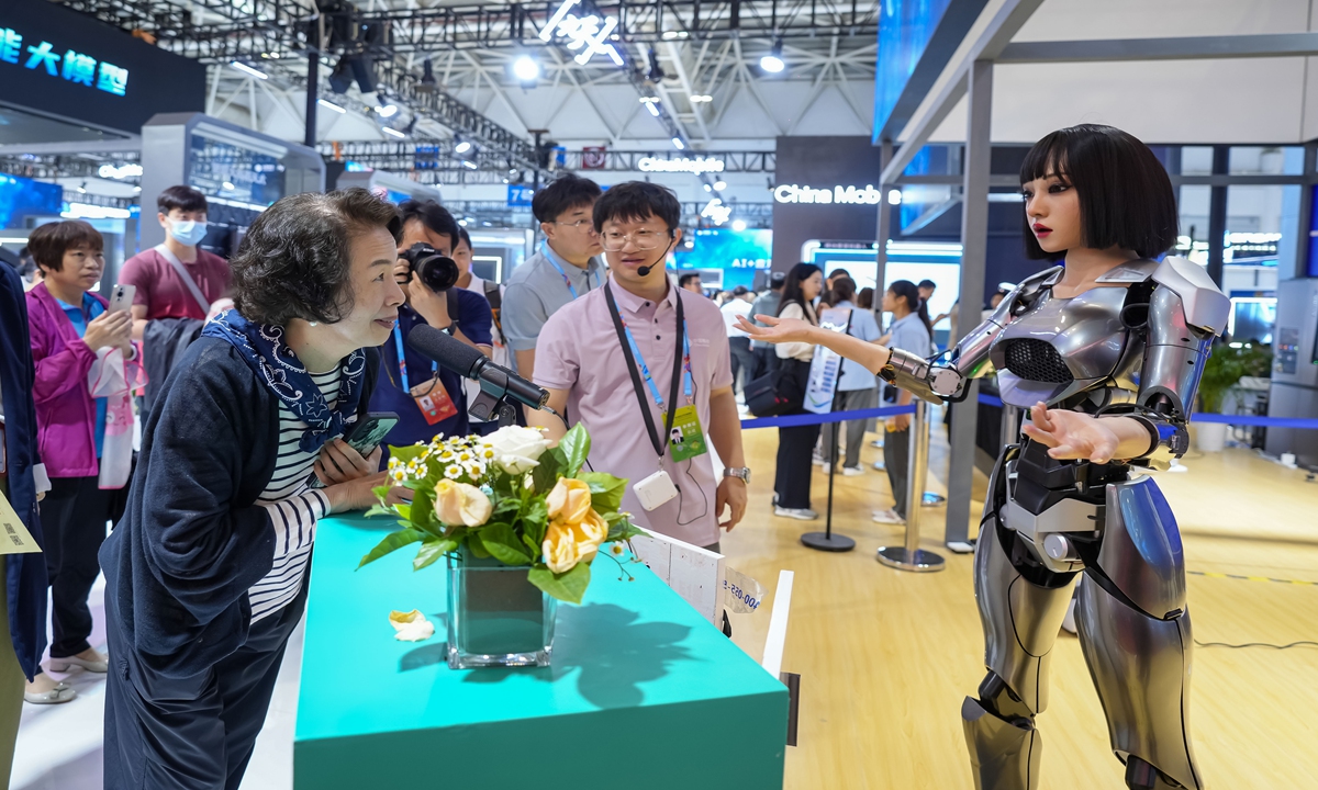 A consumer interacts with a robot powered by artificial intelligence in an exhibition center in Fuzhou, capital of East China's Fujian Province on May 23, 2024. The 7th Digital China Summit will take place at the exhibition center on Friday. This year, the venue will connect to the 5.5G internet for the first time, and it will also showcase more than 100 interactive and experience projects. Photo: VCG