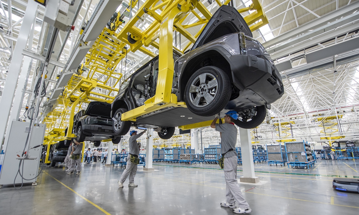 Workers assemble new-energy vehicles in Chery's assembly workshop in Wuhu city, East China's Anhui Province, on May 23, 2024. In recent years, Wuhu has prioritized this industry in its green transformation and industrial upgrading, drawing more than 300 companies across industries. Photo: VCG