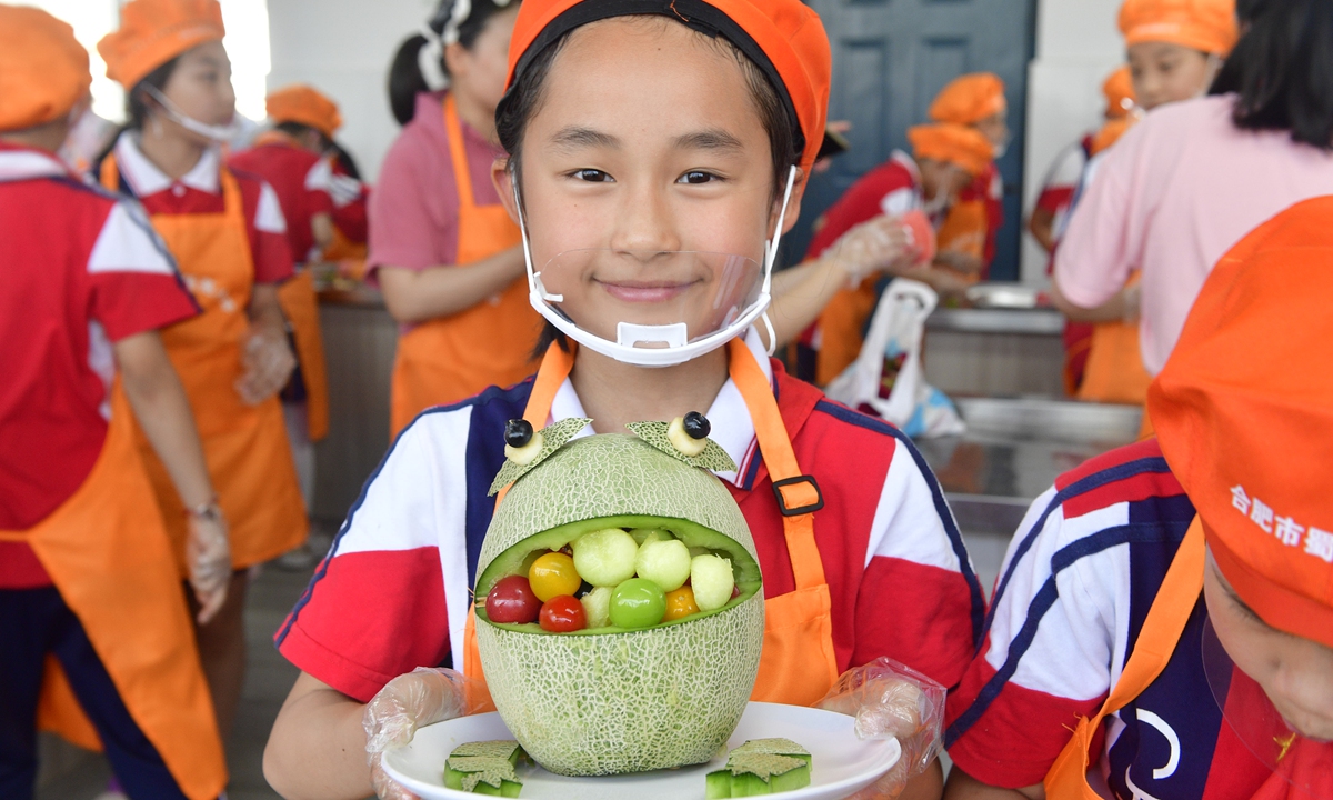 A student shows off a hand-made fruit platter at an elementary school in Hefei, East China's Anhui Province, May 22, 2024. Photo: VCG