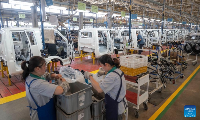 Staff members operate at an assembly line at Wuzheng Group in Wulian County, Rizhao City, east China's Shandong Province, May 23, 2024. Boasting a history dating back to 1961, Wuzheng Group has grown into an important player in China's agricultural and commercial vehicle industry, with about 10,000 staff members and total assets worthing 17 billion yuan (about 2.35 billion US dollars).(Photo: Xinhua)