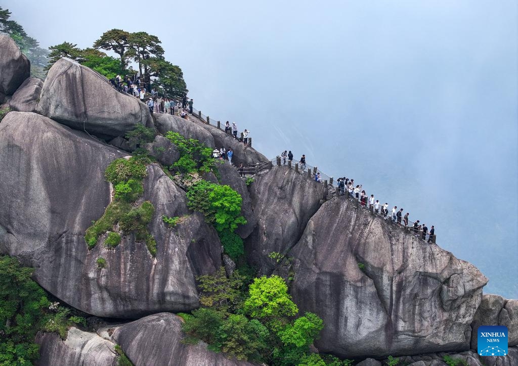 An aerial drone photo taken on May 20, 2024 shows tourists visiting the Tiandu peak in Huangshan Mountain scenic area in Huangshan City, east China's Anhui Province. The Tiandu peak, one of the most popular sites in Huangshan Mountain scenic area, has recently reopened after a rotational closure period which allows nature to rest and self-repair.(Photo: Xinhua)