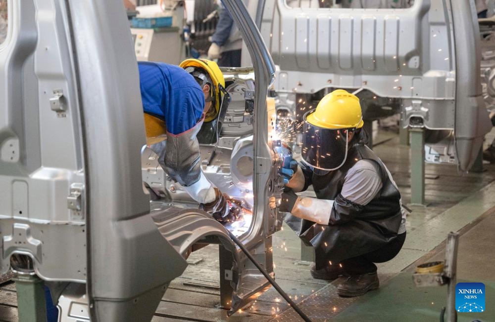 Staff members operate at an assembly line at Wuzheng Group in Wulian County, Rizhao City, east China's Shandong Province, May 23, 2024. Boasting a history dating back to 1961, Wuzheng Group has grown into an important player in China's agricultural and commercial vehicle industry, with about 10,000 staff members and total assets worthing 17 billion yuan (about 2.35 billion US dollars).(Photo: Xinhua)