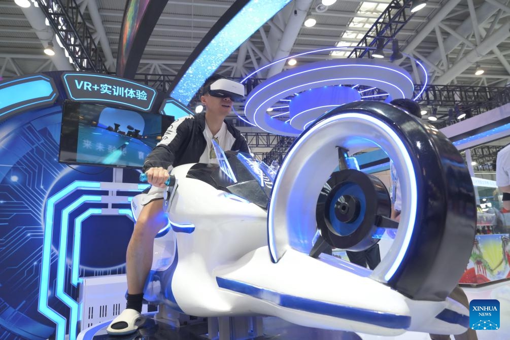 A visitor experiences motion-sensing VR game at the on-site experience area for the 7th Digital China Summit in Fuzhou, southeast China's Fujian Province, May 23, 2024. The 7th Digital China Summit will take place in Fuzhou from May 24 to 25. The preview of its on-site experience area, covering an area of 56,000 square meters and consisting of five major parts, was opened at Fuzhou Strait International Conference and Exhibition Center on Thursday.(Photo: Xinhua)