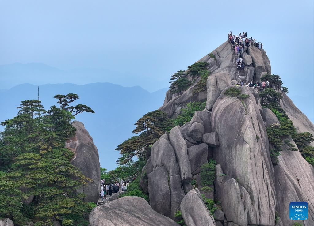 An aerial drone photo taken on May 20, 2024 shows tourists visiting the Tiandu peak in Huangshan Mountain scenic area in Huangshan City, east China's Anhui Province. The Tiandu peak, one of the most popular sites in Huangshan Mountain scenic area, has recently reopened after a rotational closure period which allows nature to rest and self-repair.(Photo: Xinhua)