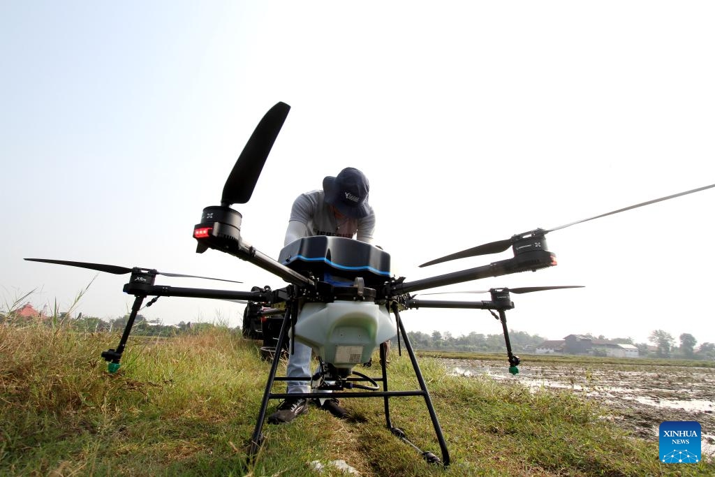 An operator prepares an agricultural drone to spray herbicide at a paddy field in Sukoharjo, Central Java, Indonesia, May 23, 2024. Agricultural drones are used here to help local farmers do farm work in a more efficient, convenient and safe way.(Photo: Xinhua)