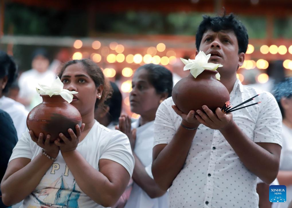 People take part in a religious observance of the Vesak Festival at a temple in Colombo, Sri Lanka, May 23, 2024. The Vesak Festival is one of the holiest festivals celebrated in Sri Lanka as it marks the birth, enlightenment and demise of Lord Buddha.(Photo: Xinhua)