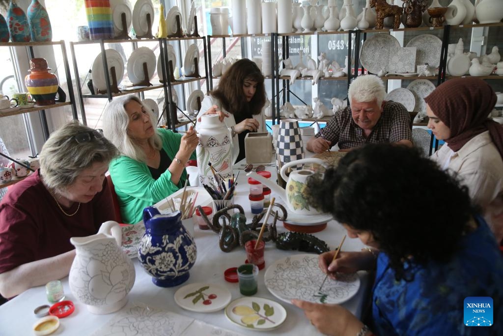 A group of participants, who are suffering from various health issues, mold clay and make ceramic objects in a studio in Ankara, Türkiye, on May 22, 2024. People suffering from various health issues are finding therapeutic solace offered by female Turkish ceramist Duygu Kavukcu willing to go the extra mile for those in need of inner well-being and emotional support.(Photo: Xinhua)