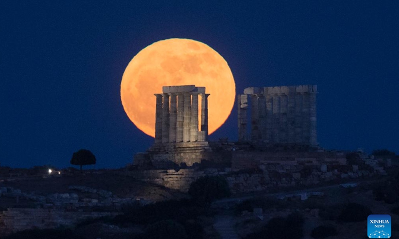 A full moon rises behind the Temple of Poseidon at Cape Sounion, Greece, May 23, 2024. (Xinhua/Marios Lolos)

