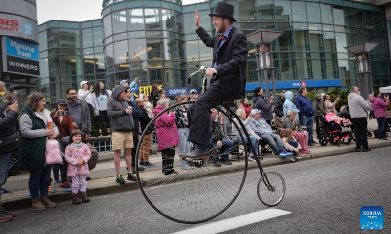 A performer rides a vintage bicycle during the annual Hyack International Parade in New Westminster, British Columbia, Canada, on May 25, 2024. (Photo:Xinhua)