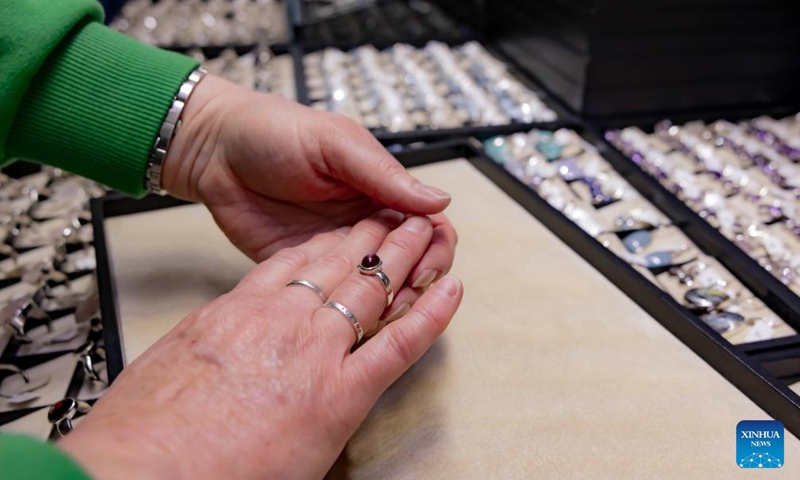 A person tries a ring displayed at 2024 Canberra Winter Gemcraft and Mineral Show at the Exhibition Park in Canberra, Australia, May 25, 2024. (Photo:Xinhua)