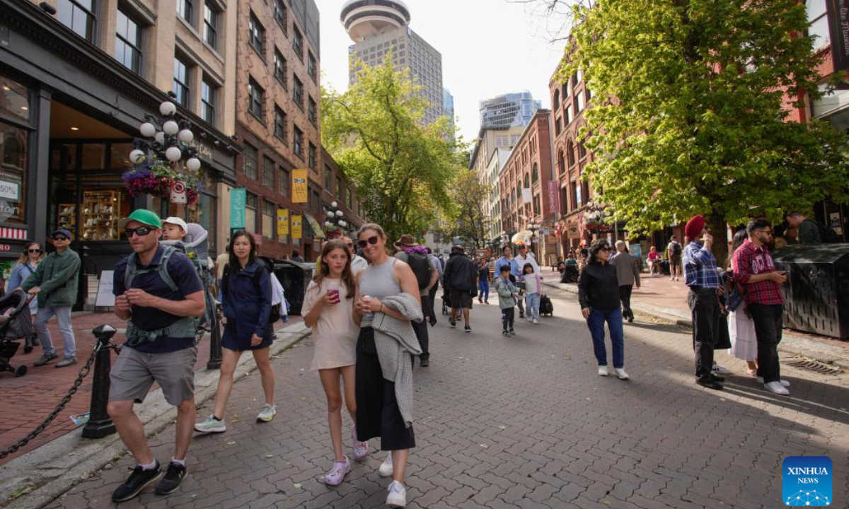 Visitors enjoy their day on a street in Gastown, which has turned into a pedestrian zone, in Vancouver, British Columbia, Canada, June 28, 2024. (Photo: Xinhua)