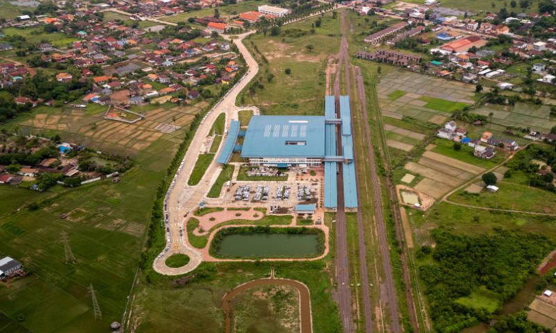 An aerial drone photo taken on July 20, 2024 shows the first Laos-Thailand cross-border passenger train arriving at Khamsavath railway station in Vientiane, Laos. The Laos-Thailand cross-border passenger train has officially started operation, running between Krung Thep Aphiwat Central station in the Thai capital of Bangkok and Khamsavath railway station in Lao capital Vientiane. (Photo by Kaikeo Saiyasane/Xinhua)