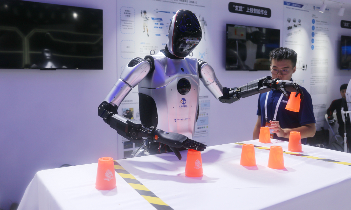 Visitors watch a robotic dog performance at an exhibition during the World AI Conference, on July 6, 2024. Photo: Leng Shumei/GT
