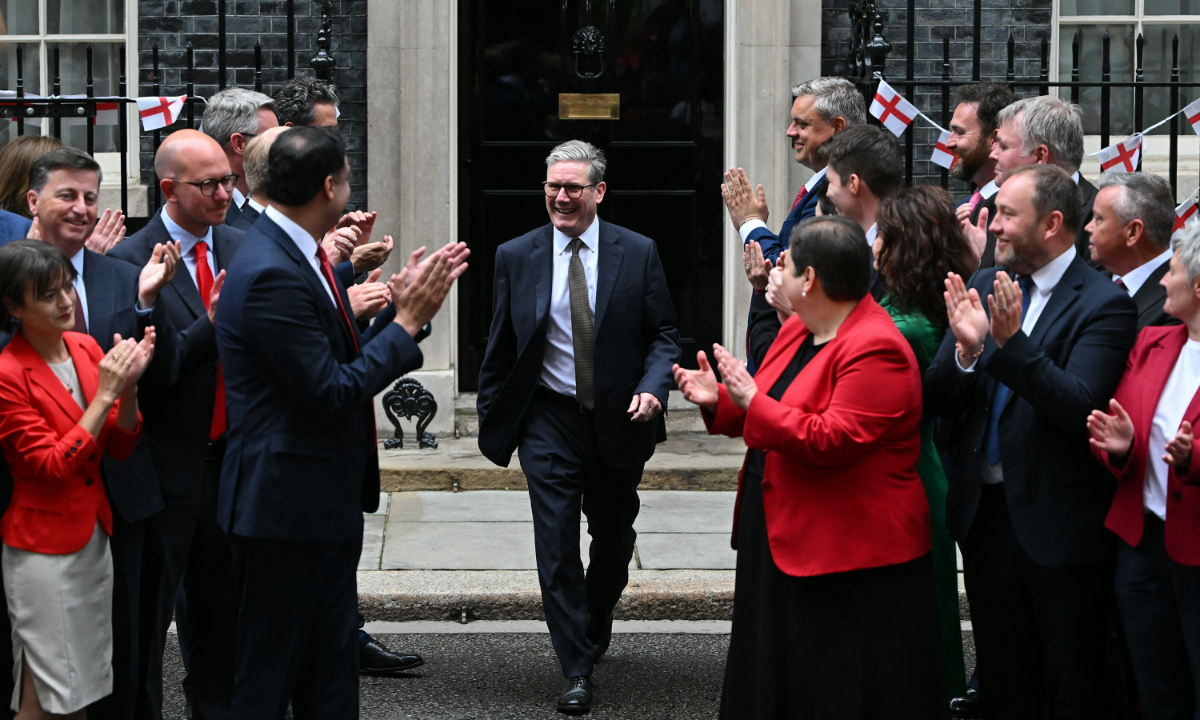 Britain's Prime Minister Keir Starmer (center) is applauded as he steps out of 10 Downing Street to greet newly elected Scottish MPs in London on July 9, 2024 at the end of the weekly cabinet meeting. Photo: AFP