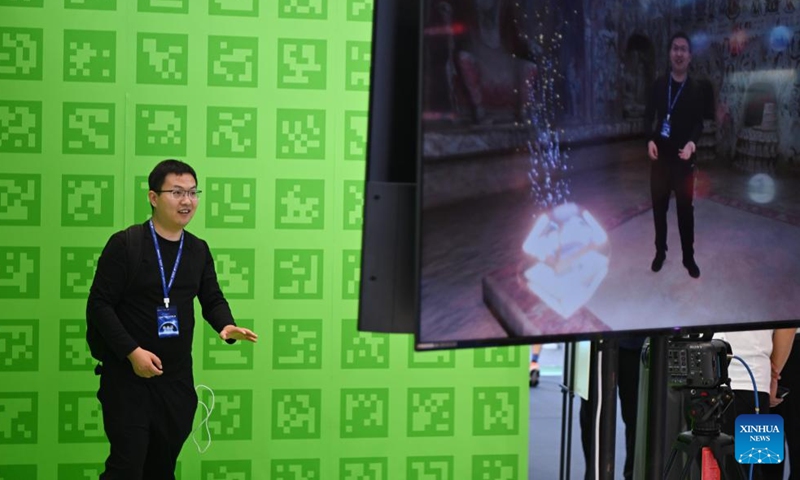 A visitor gestures as he tests real-time video special effects synthesis technology during the 20th China (Shenzhen) International Cultural Industries Fair (ICIF) in Shenzhen, south China's Guangdong Province, May 23, 2024. The 20th ICIF opened on Thursday in the southern Chinese metropolis of Shenzhen. The fair will showcase new business forms and new applications through the combination of multimedia such as AI and AR. (Photo: Xinhua)