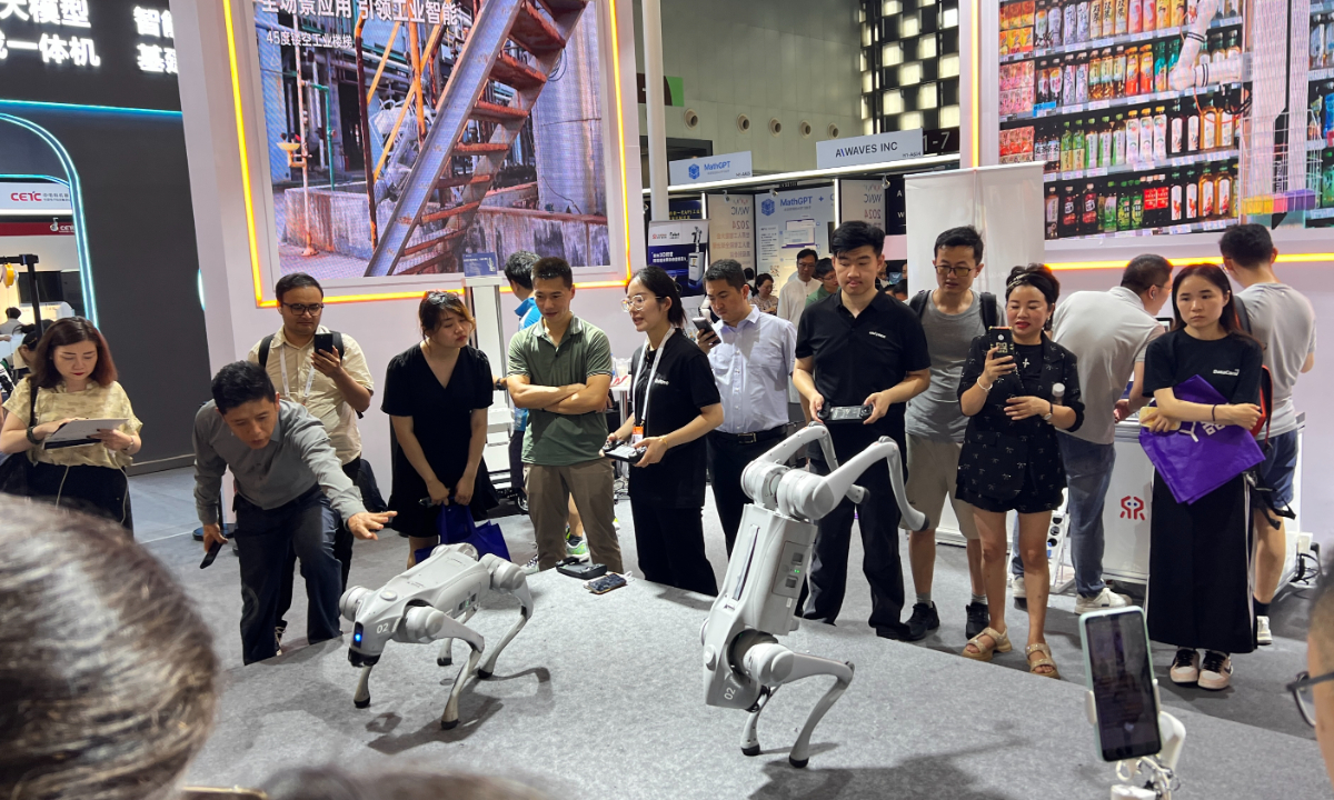 Visitors watch a robotic dog performance at an exhibition during the World AI Conference, on July 6, 2024. Photo: Leng Shumei/GT