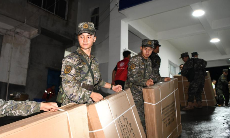 Rescue members carry relief supplies at Xinhua primary school in Malie Township, Hanyuan County, Ya'an City, southwest China's Sichuan Province, July 20, 2024. (Xinhua/Wang Xi)