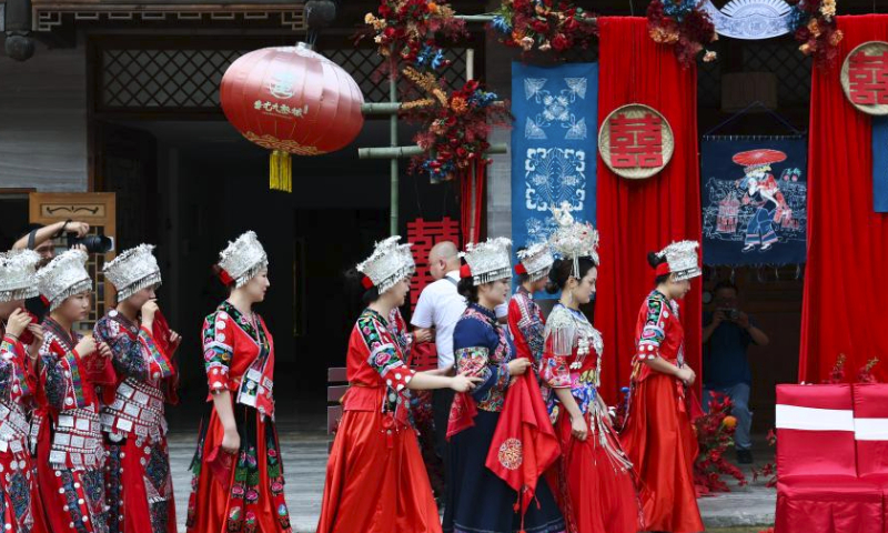 A wedding with Miao ethnic group features is pictured at Chiyou Jiuli Town scenic spot of Pengshui Miao-Tujia Autonomous County, southwest China's Chongqing, July 20, 2024. Local authorities of Pengshui Miao-Tujia Autonomous County has taken advantages of ethnic features to promote its summer tourism. (Photo by Lan Hongguang/Xinhua)