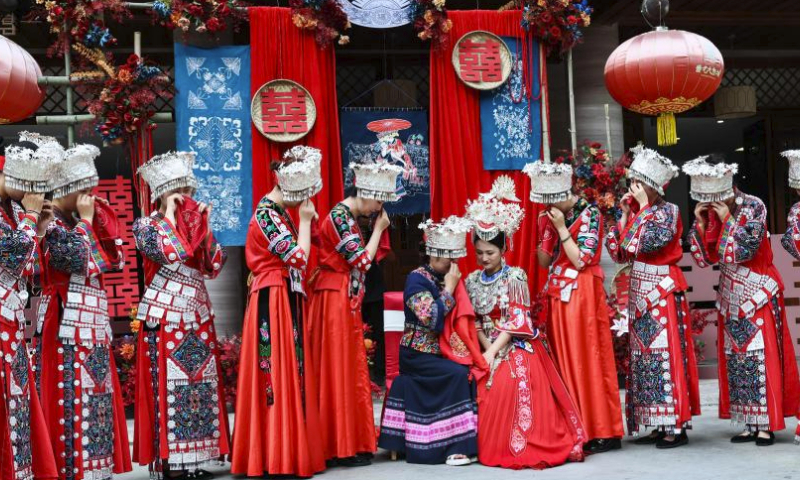 A wedding with Miao ethnic group features is pictured at Chiyou Jiuli Town scenic spot of Pengshui Miao-Tujia Autonomous County, southwest China's Chongqing, July 20, 2024. Local authorities of Pengshui Miao-Tujia Autonomous County has taken advantages of ethnic features to promote its summer tourism. (Photo by Lan Hongguang/Xinhua)