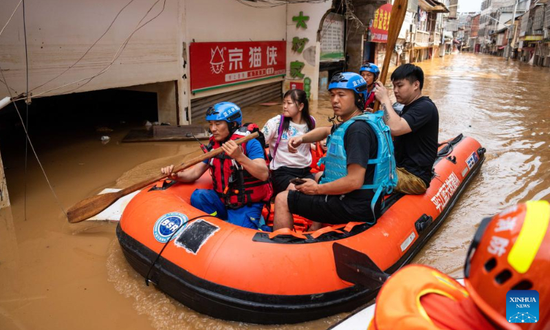 Rescuers transfer stranded residents in Pingjiang county, central China's Hunan Province, July 2, 2024. The flooding water in Pingjiang county is gradually declining. Photo: Xinhua