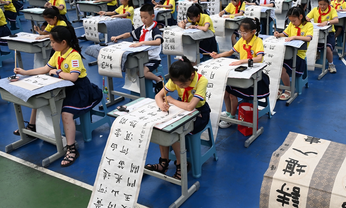 Primary school students participate in a calligraphy and painting competition during a campus cultural and arts festival on May 27, 2024 in Neijiang, Southwest China's Sichuan Province. This event aims to inherit and promote excellent traditional Chinese culture and celebrate the upcoming International Children's Day. Photo: VCG