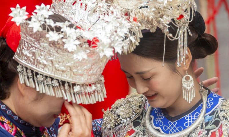 A wedding with Miao ethnic group features is pictured at Chiyou Jiuli Town scenic spot of Pengshui Miao-Tujia Autonomous County, southwest China's Chongqing, July 20, 2024. Local authorities of Pengshui Miao-Tujia Autonomous County has taken advantages of ethnic features to promote its summer tourism. (Photo by Li Xiaoguo/Xinhua)