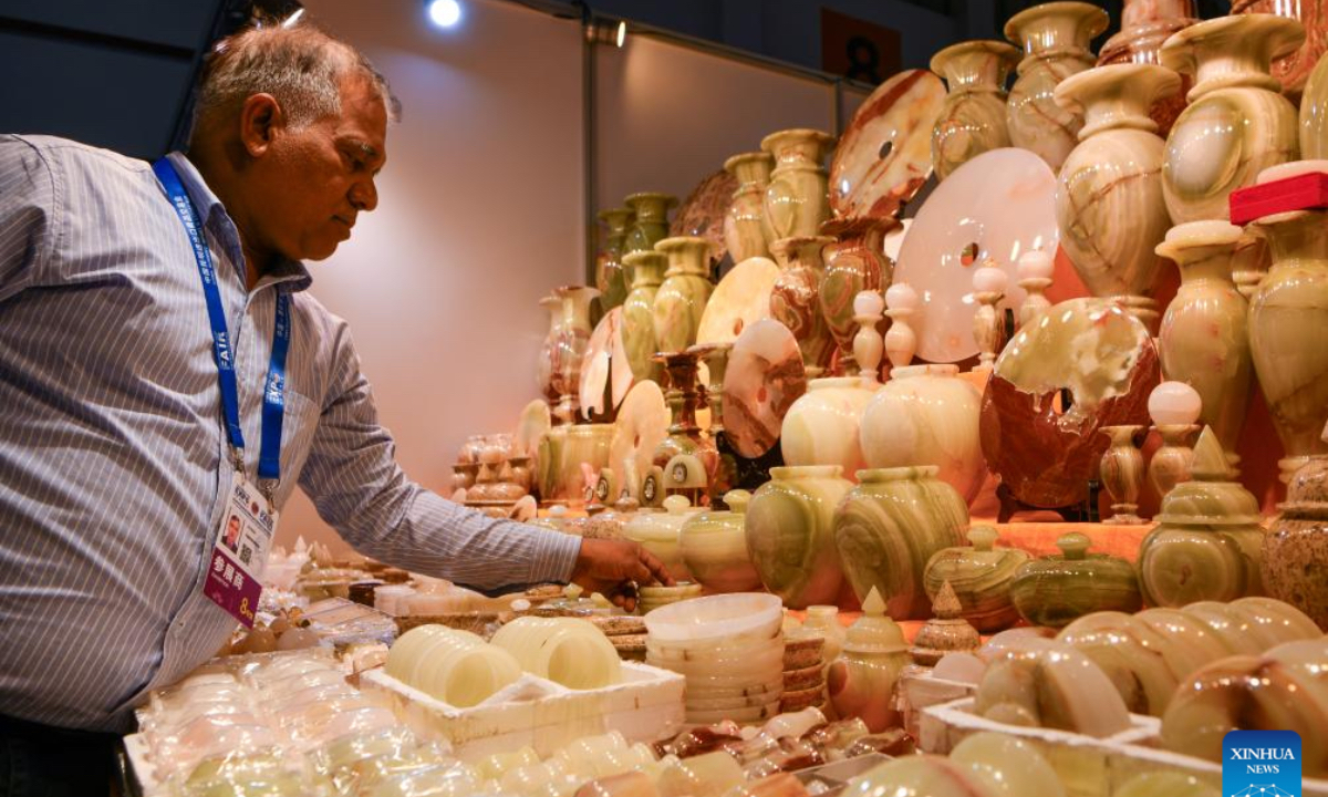 A Pakistani exhibitor arranges exhibits at the South Asia Pavilion during the 8th China-South Asia Expo in Kunming, southwest China's Yunnan Province, July 26, 2024. The 8th China-South Asia Expo runs from July 23 to 28 in Kunming. The expo presents 15 pavilions, including two dedicated to South Asian countries, showcasing a total of approximately 800 booths. (Photo: Xinhua)