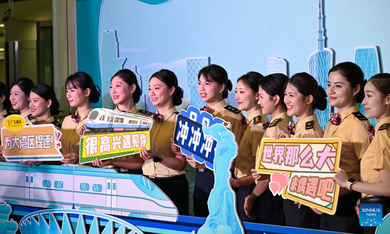 Railway workers pose for photos at a ceremony marking the connection of four intercity railways linking cities of Zhaoqing, Foshan, Guangzhou, Dongguan and Huizhou at the Panyu Station in Guangzhou, south China's Guangdong Province, May 26, 2024. (Photo: Xinhua)