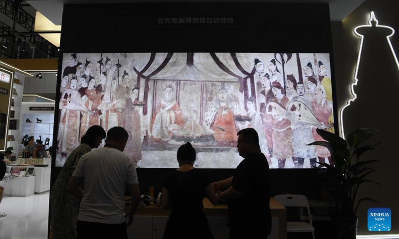 People visit a digitized interactive exhibition of ancient Chinese murals during the 20th China (Shenzhen) International Cultural Industries Fair (ICIF) in Shenzhen, south China's Guangdong Province, May 24, 2024. The 20th ICIF opened on Thursday in the southern Chinese metropolis of Shenzhen. The fair will showcase new business forms and new applications through the combination of multimedia such as AI and AR. (Photo: Xinhua)