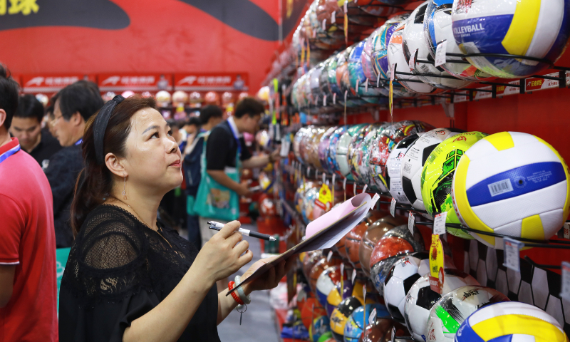 A buyer records the data of balls at the China Yiwu Stationery & Gift Exhibition in Yiwu, East China's Zhejiang Province, on June 3, 2024. With the approach of the Olympic Games Paris 2024, all kinds of sporting goods and Olympic-related products are popular at the exhibition, with brisk sales. Photo: VCG