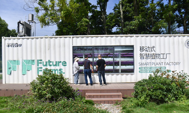 Visitors are attracted by a “mobile smart plant factory” transformed from a container in Chengdu, Southwest China’s Sichuan Province, on May 30, 2024. The container can be moved to different locations according to different needs. By using technologies such as nutrient cultivation and smart environmental controls, the smart factory can meet the planting needs of multiple varieties including vegetables, sprouts, fruits and flowers. Photo: VCG 