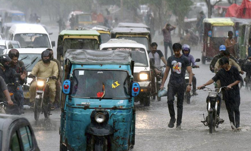 Vehicles wade through a flooded road during heavy rain in southern Pakistani port city of Karachi on July 20, 2024. (Str/Xinhua)