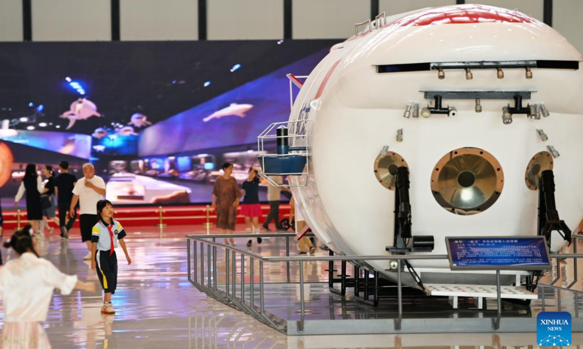 People watch a model of Jiaolong, China's deep-sea manned submersible, at the National Maritime Museum of China in Tianjin, north China, June 28, 2024. The National Maritime Museum of China is located in Tianjin Binhai New Area, covering an area of 15 hectares. As the summer vacation approaches, the number of visitors to the museum has increased. (Photo: Xinhua)