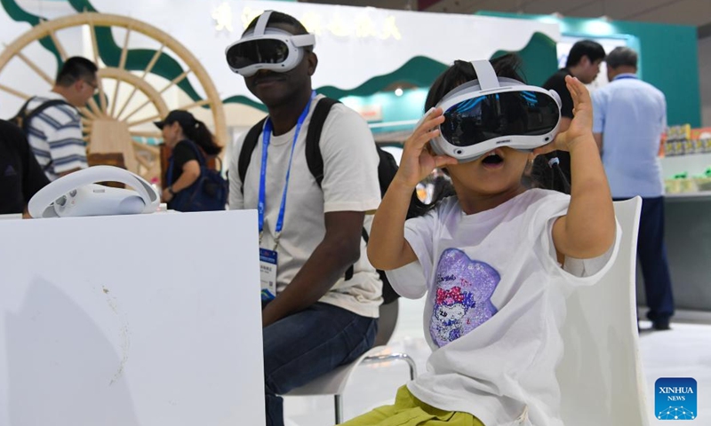 People try VR devices during the 20th China (Shenzhen) International Cultural Industries Fair (ICIF) in Shenzhen, south China's Guangdong Province, May 23, 2024. The 20th ICIF opened on Thursday in the southern Chinese metropolis of Shenzhen. The fair will showcase new business forms and new applications through the combination of multimedia such as AI and AR. (Photo: Xinhua)