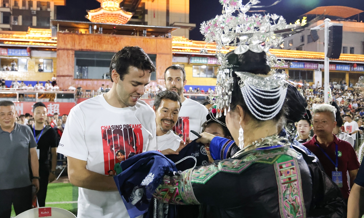 Brazilian soccer player Kaka (first from left) interacts with local residents and visitors from the Village Super League, also dubbed 