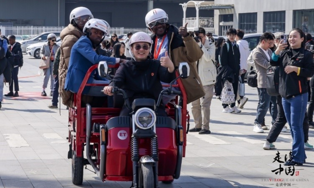 Foreign journalists ride tricycles at the Yadea Industrial Park in Wuxi,<strong></strong> East China's Jiangsu Province on March 20, 2024. Photo: huanqiu.com