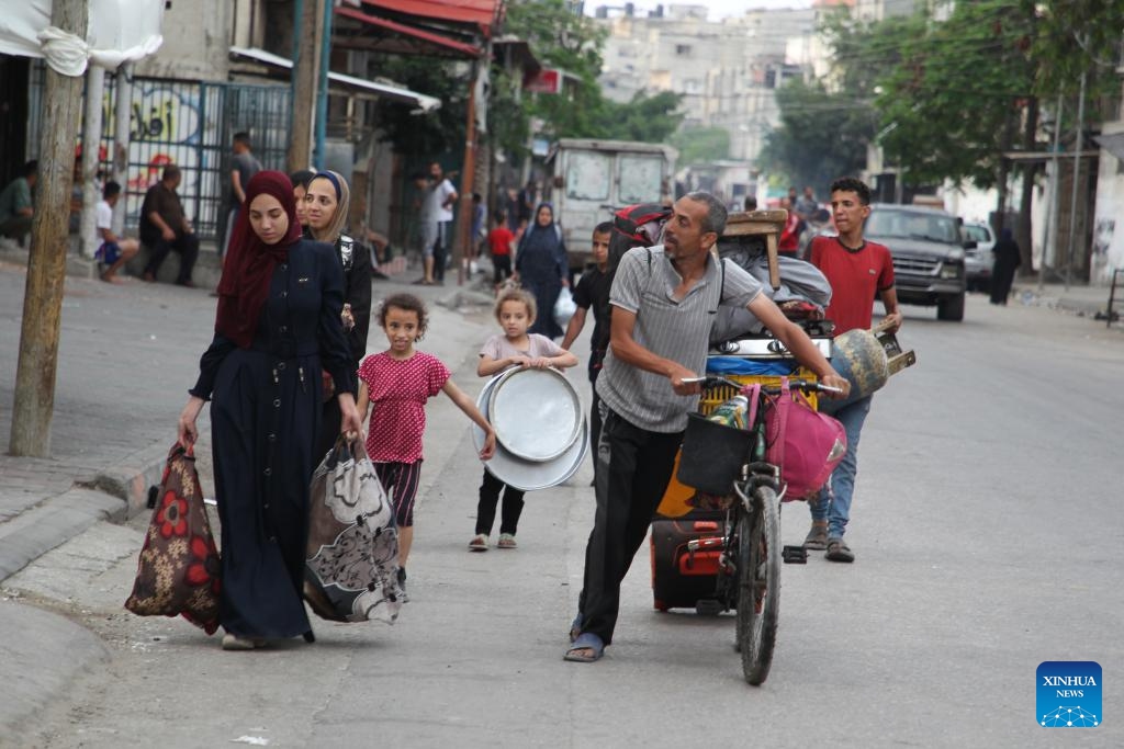 Palestinians flee from home in the southern Gaza Strip city of Rafah, on May 28, 2024. The United Nations Relief and Works Agency for Palestine Refugees said on social media platform X that nearly one million people were forced to flee from Rafah during the past three weeks, as a result of the Israeli bombing of the city.(Photo: Xinhua)