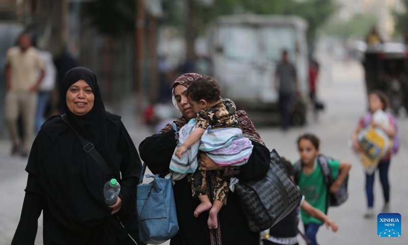 Palestinians flee from home in the southern Gaza Strip city of Rafah, on May 28, 2024. The United Nations Relief and Works Agency for Palestine Refugees said on social media platform X that nearly one million people were forced to flee from Rafah during the past three weeks, as a result of the Israeli bombing of the city.(Photo: Xinhua)