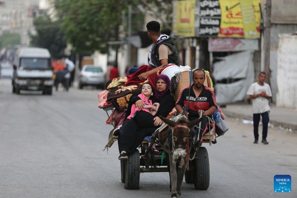 Palestinians flee from home in the southern Gaza Strip city of Rafah, on May 28, 2024. The United Nations Relief and Works Agency for Palestine Refugees said on social media platform X that nearly one million people were forced to flee from Rafah during the past three weeks, as a result of the Israeli bombing of the city.(Photo: Xinhua)