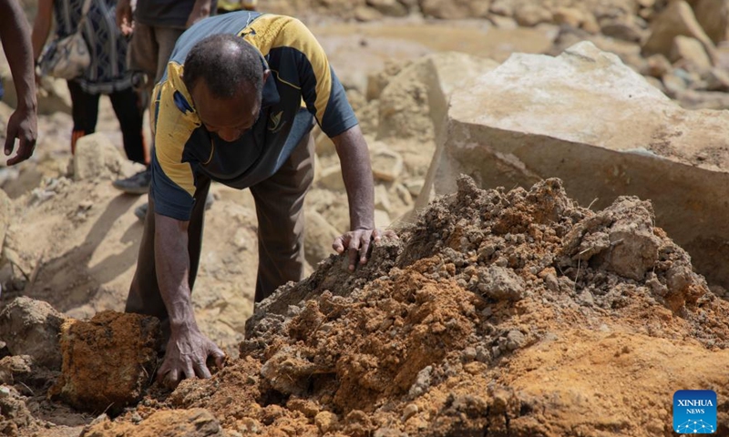 A man searches the site of a landslide in Yambali village, Enga Province, Papua New Guinea, May 27, 2024. It is highly unlikely to find any more survivors from the massive landslide in Papua New Guinea (PNG)'s remote Enga Province, a UN official said on Tuesday. The Papua New Guinea National Disaster Center has confirmed that more than 2,000 people were buried alive after the massive landslide occurred in Enga Province.(Photo: Xinhua)