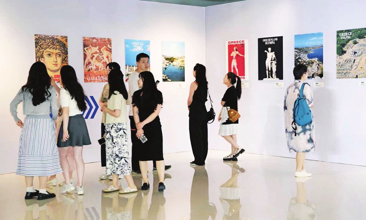 Visitors appreciate posters at the exhibition in Chengdu. Photo: Courtesy of the Greek Embassy in China

