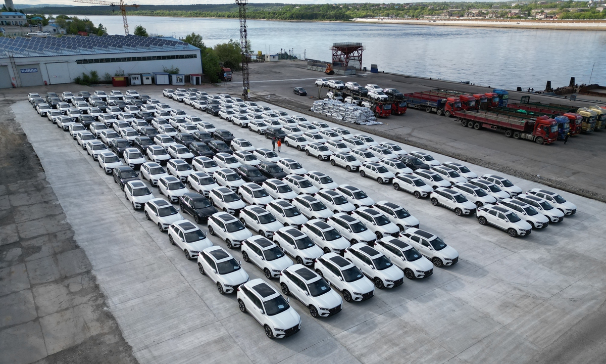 The first batch of 104 China-made cars is transported by barge from Heihe port in Northeast China's Heilongjiang Province to Blagoveshchensk in Russia on May 30, 2024. It marks the official start of bulk exports of T77 model cars from Heihe, a breakthrough in the introduction of new types of export cargo through the port. Photo: VCG