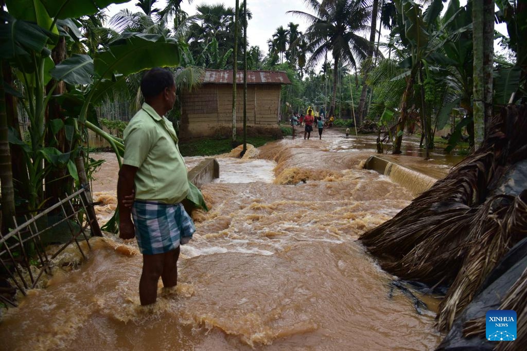 A villager stands in flood water after heavy rains following the landfall of Cyclone Remal in Nagaon district, Assam, northeastern India, on May 29, 2024. Storms and rainfall-induced landslides triggered in the aftermath of Cyclone Remal killed at least 32 people and injured many others across India's West Bengal and four northeastern states, officials said Tuesday.(Photo: Xinhua)