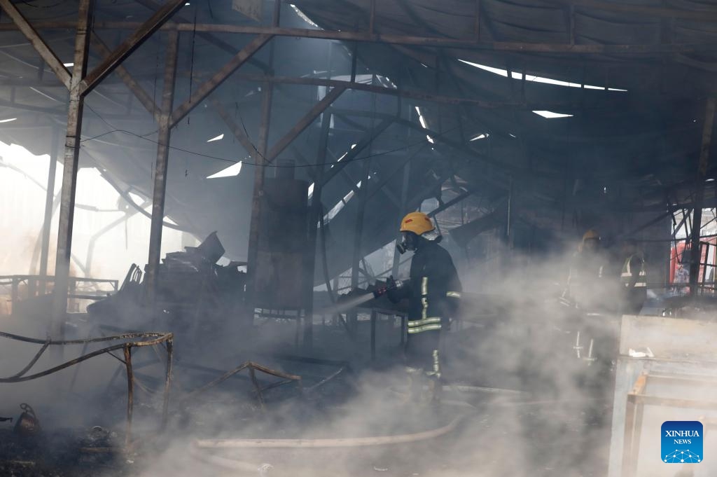 Firefighters work at a market where a fire broke out after clashes between Palestinians and the Israeli army in the West Bank city of Ramallah, on May 30, 2024.(Photo: Xinhua)