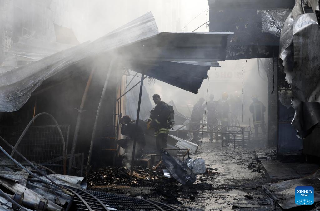 Firefighters work at a market where a fire broke out after clashes between Palestinians and the Israeli army in the West Bank city of Ramallah, on May 30, 2024.(Photo: Xinhua)