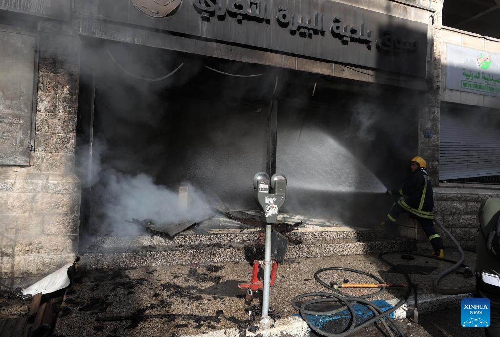 A firefighter works at a market where a fire broke out after clashes between Palestinians and the Israeli army in the West Bank city of Ramallah, on May 30, 2024.(Photo: Xinhua)