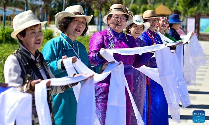 Villagers greet tourists at an agro-tourism area in Emin County, Tacheng Prefecture, northwest China's Xinjiang Uygur Autonomous Region, May 30, 2024. Xinjiang in northwest China has entered its peak tourism season recently. Emin County, located near the China-Kazakhstan border, is a popular tourist destination which provides various rural tour routes and cultural events. (Photo: Xinhua)