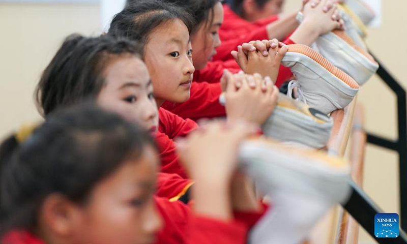 Xie Suqian (front), a pupil of the little Kunqu Opera training class, practices basic skills of Kunqu Opera with her classmates at Shipai Center Primary School of Kunshan in Kunshan City, east China's Jiangsu Province, May 30, 2024. (Photo: Xinhua)