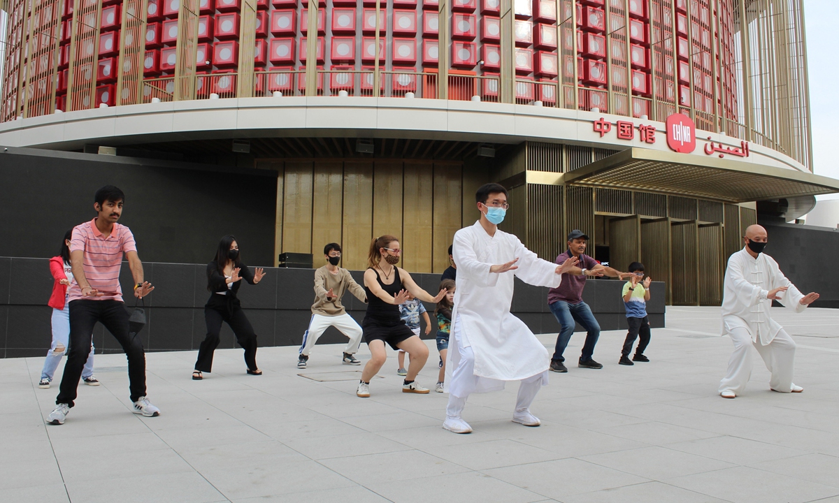  A Chinese teacher (center) teaches foreign tourists to experience traditional Chinese martial arts in front of the Chinese Pavilion during the the Dubai Expo 2020. Photo: cnsphoto 